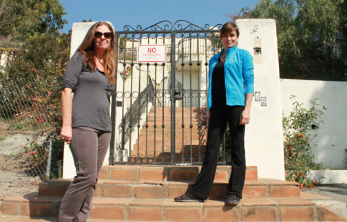 Lorraine Totino (left) and Sue Jernigan stand in front of the City-owned property at 412 Paseo Miramar. The property, which has been marred by landslide issues, is a prime example of the neighborhood's many geological problems. Photo: Reza Gostar